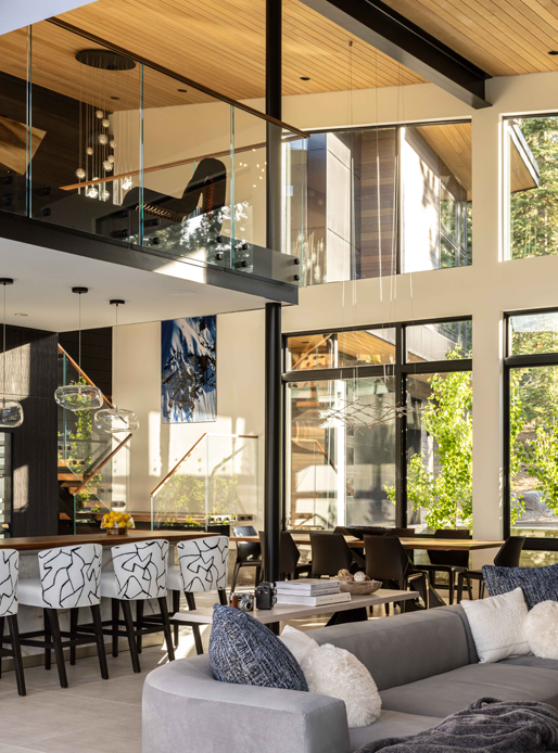 Modern living area with floor to ceiling picture and awning windows